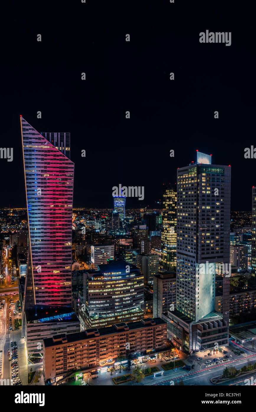 Warsaw cityscape. Panoramic view on the illuminated city buildings at night in capital of Poland. Urban nightscape. Stock Photo