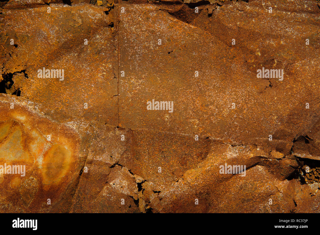sheets of dry rusted metal from side of coroded galvanised bucket. Stock Photo