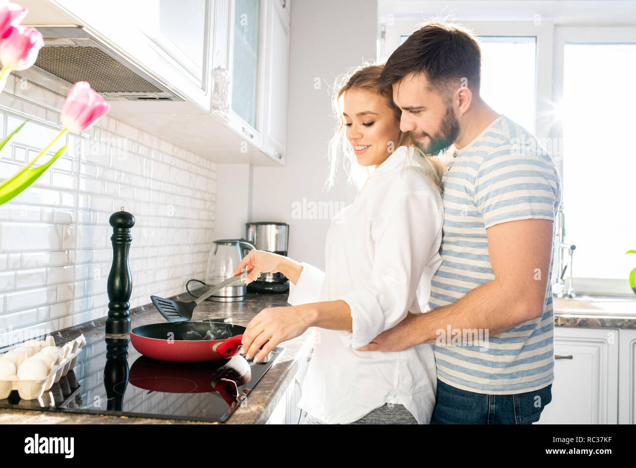 Loving Couple Cooking Breakfast In Kitchen Stock Photo Alamy