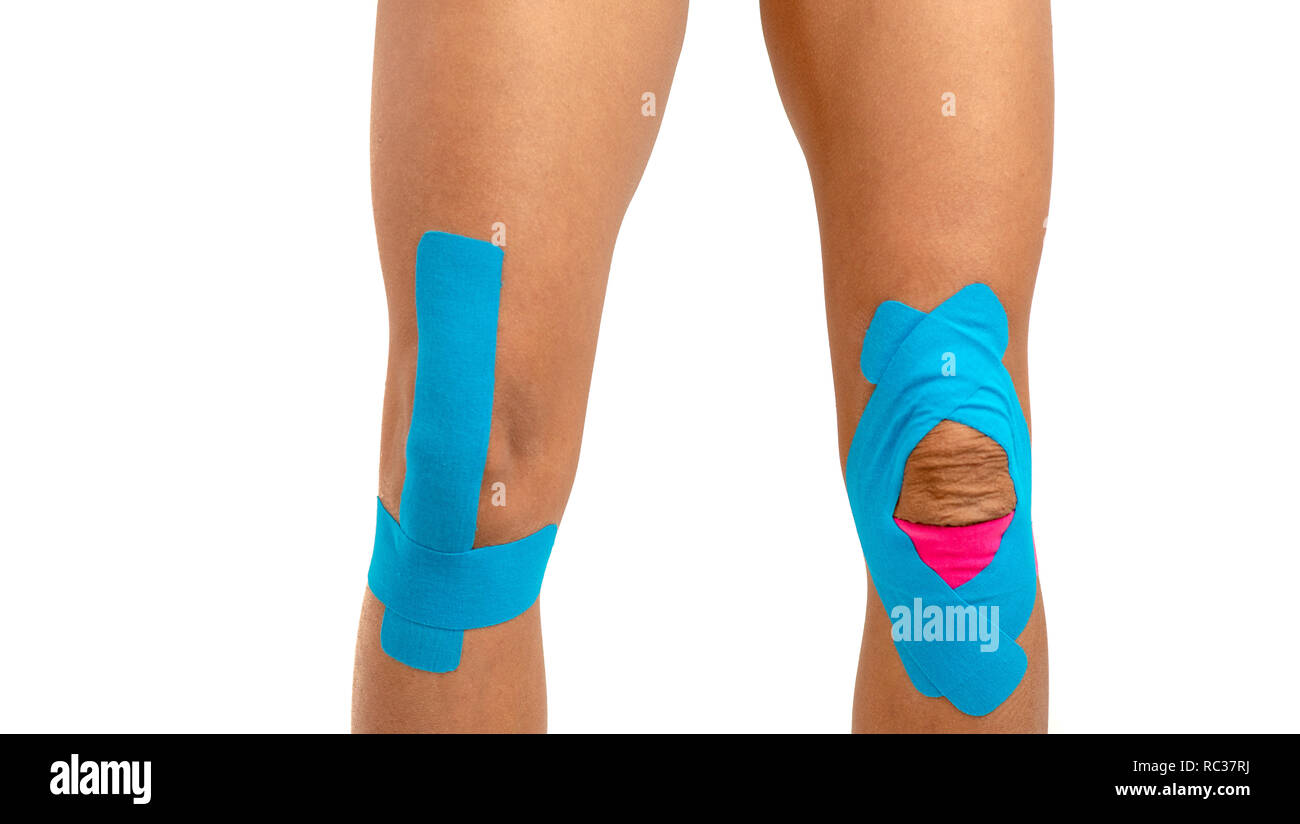 Female knee with physio tape on white background Stock Photo - Alamy