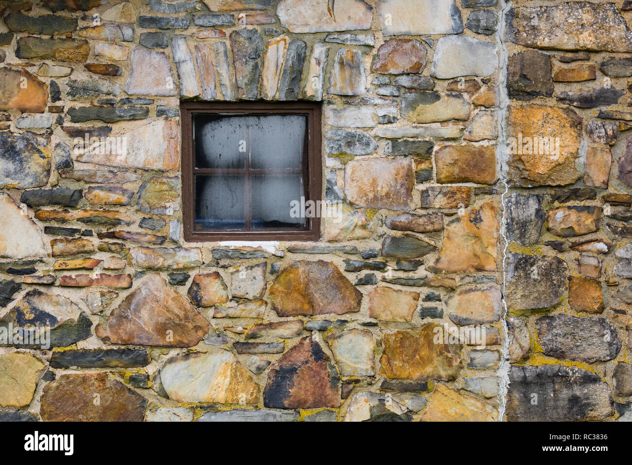 Old stone building wall with frosty square window Stock Photo - Alamy