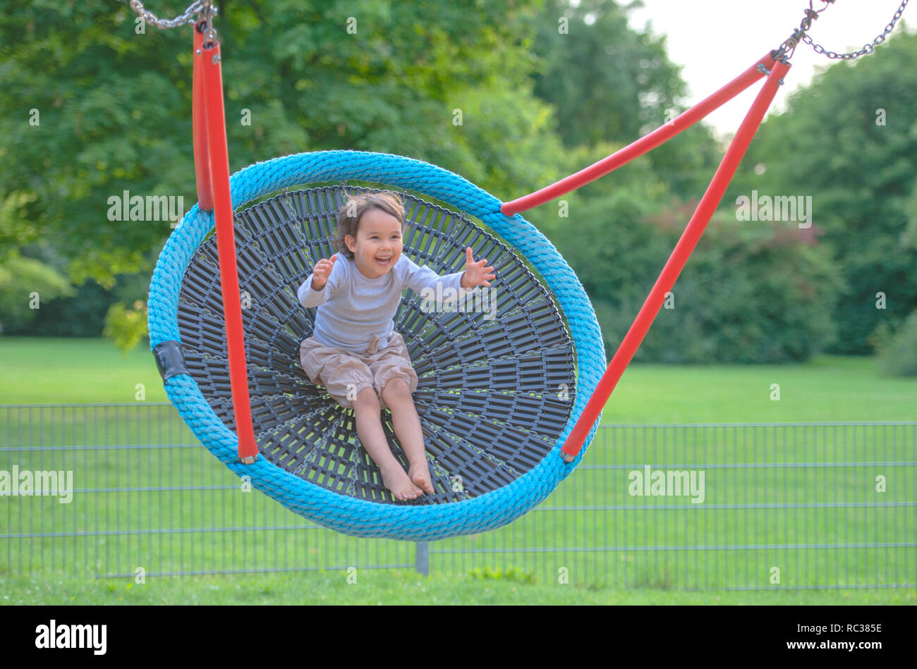 Little girl having fun in one rounded swing Stock Photo Alamy