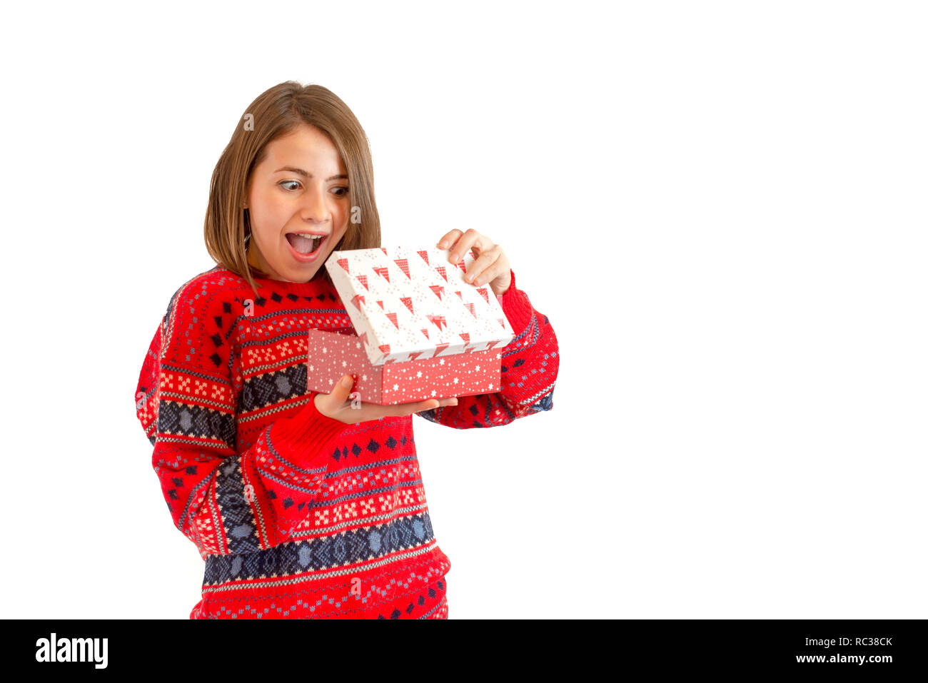 Portrait of a happy cute woman holding gift box isolated on a white background Stock Photo
