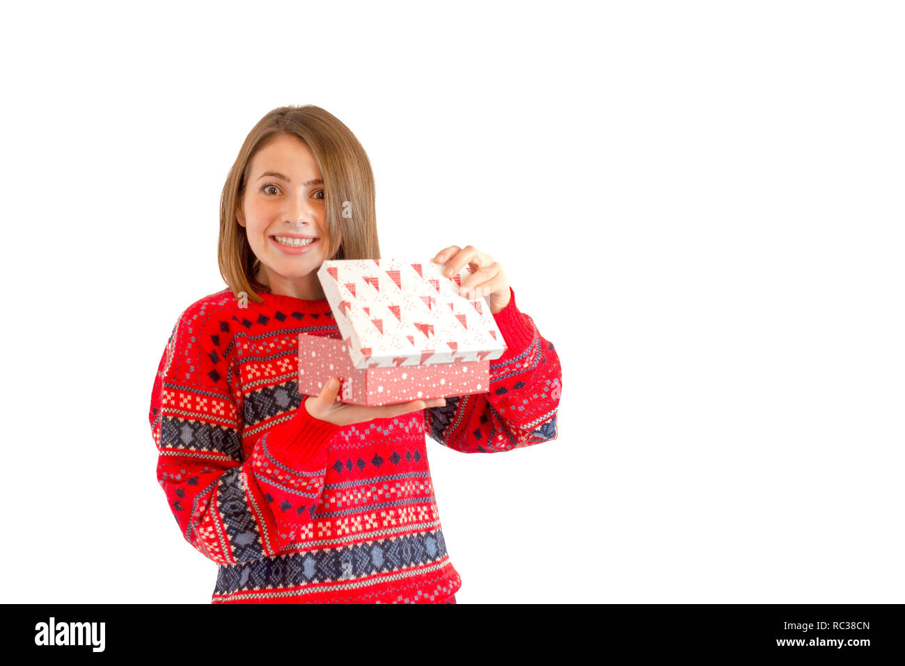 Portrait of a happy cute woman holding gift box isolated on a white background Stock Photo