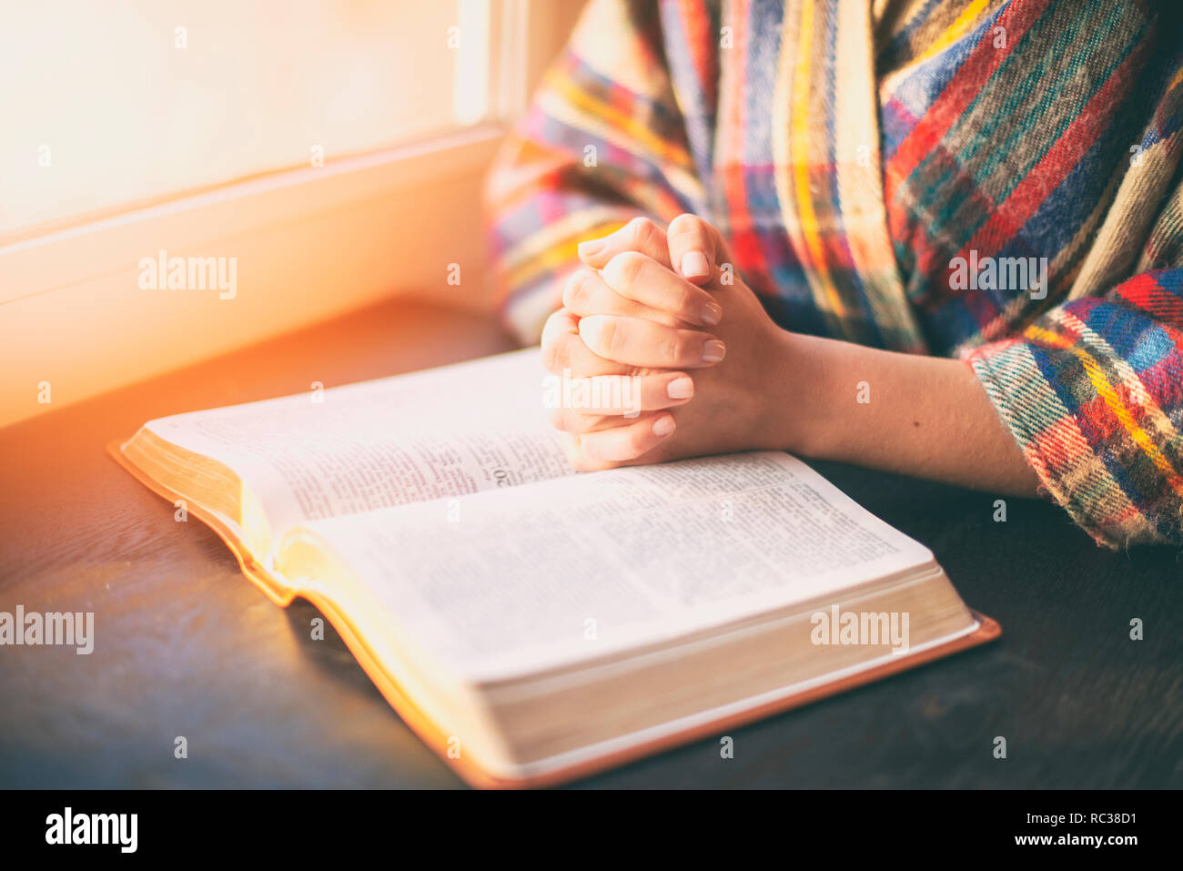 Beautiful woman praying having the Bible opened in front of he Stock Photo  - Alamy
