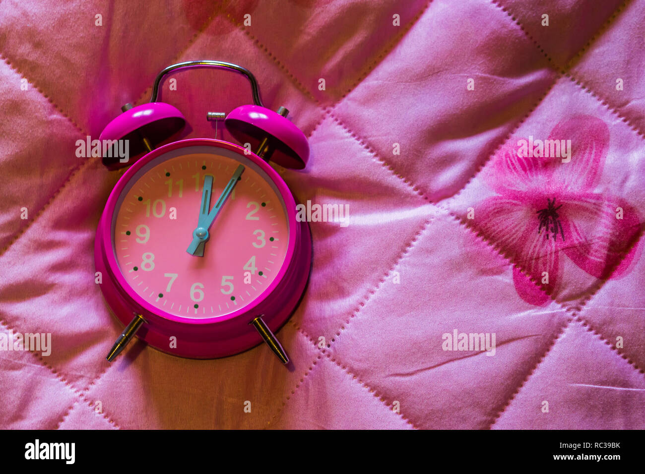 pink girly vintage alarm clock isolated on a pink blanket background Stock Photo Alamy