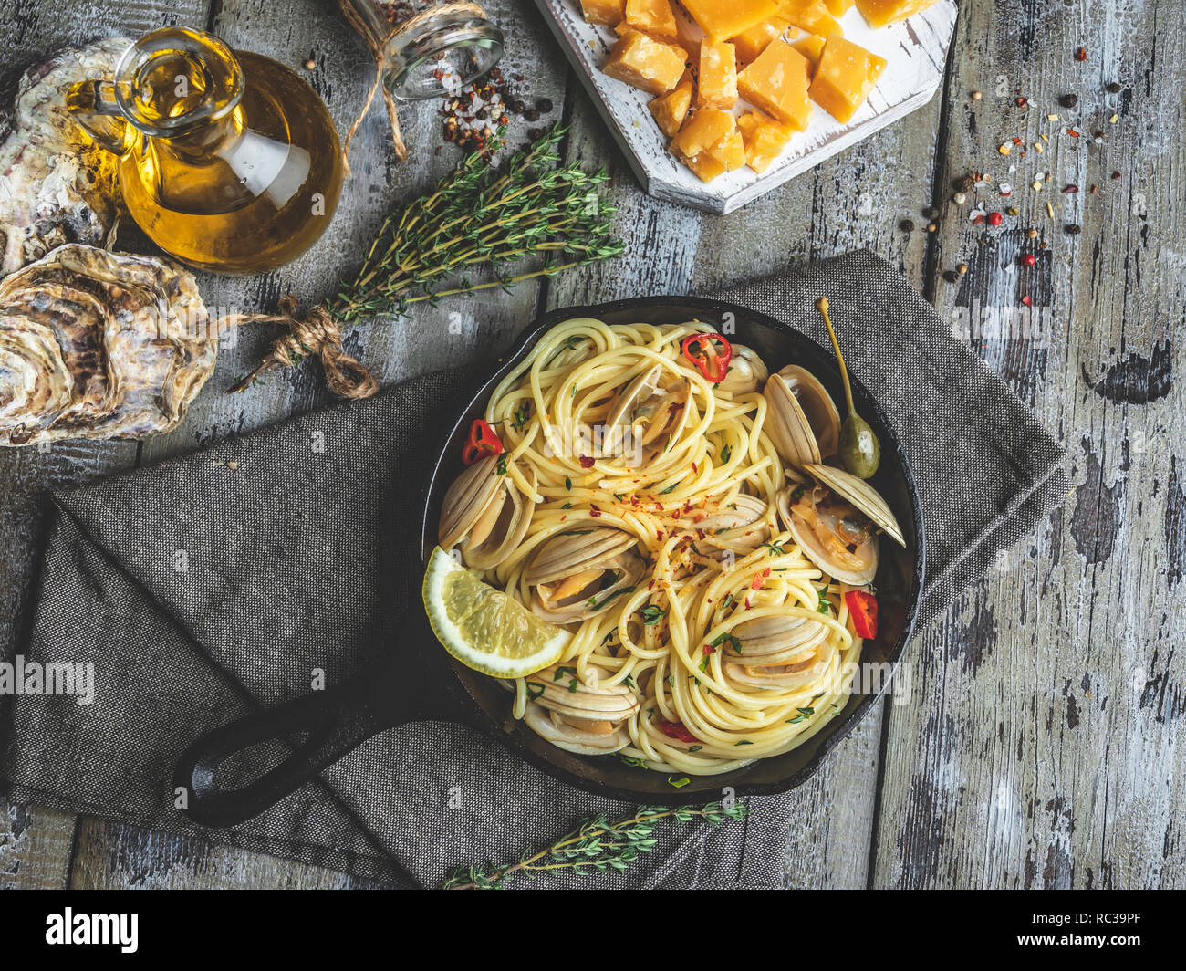 Pasta with seafood, shellfish clams in the iron pan portion, with lemon and seasoning Stock Photo