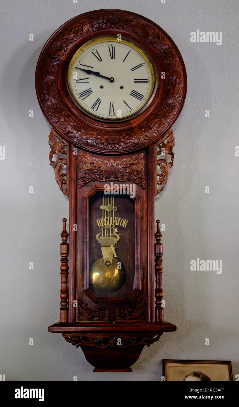 Antique Regulator ornate carved wooden pendulum wall clock with Roman  Numerals clock face Stock Photo - Alamy