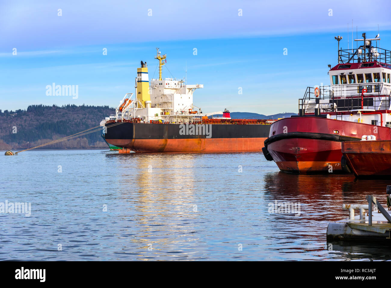 Large tanker and tugboat moored in Rainier Oregon state. Stock Photo