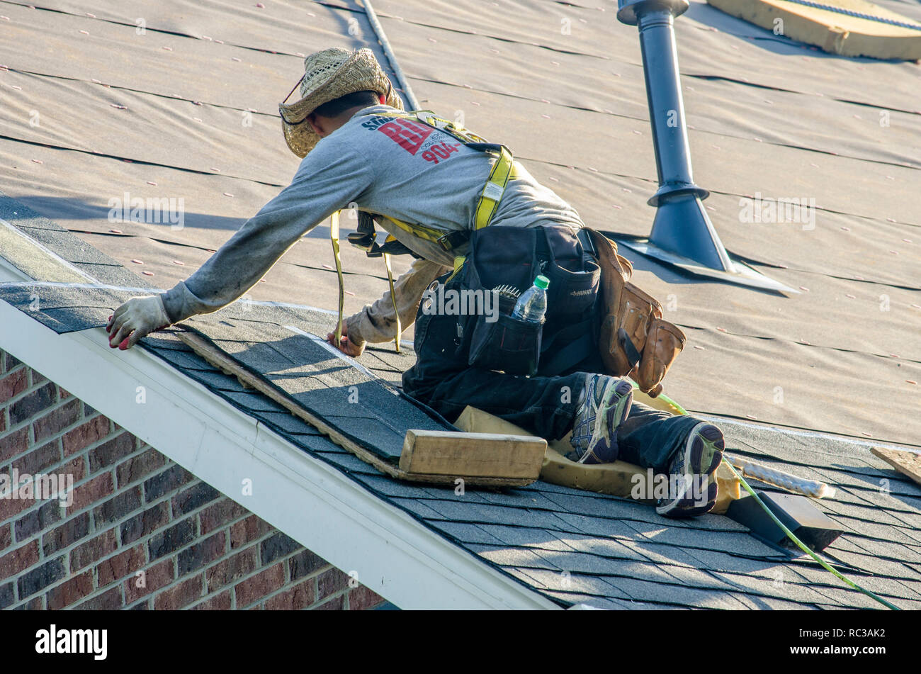 Roofing Contractors Replacing Damaged Roofs After a Hail Storm Stock