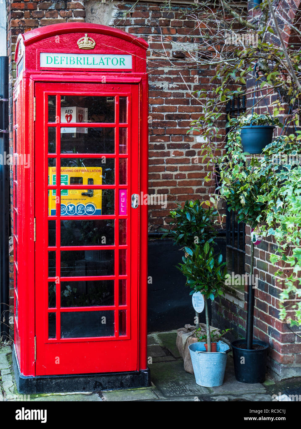 Phone Box defibrillator - Many British Red Telephone boxes have been converted into defibrillator locations. Red Phone Box reuse. Stock Photo