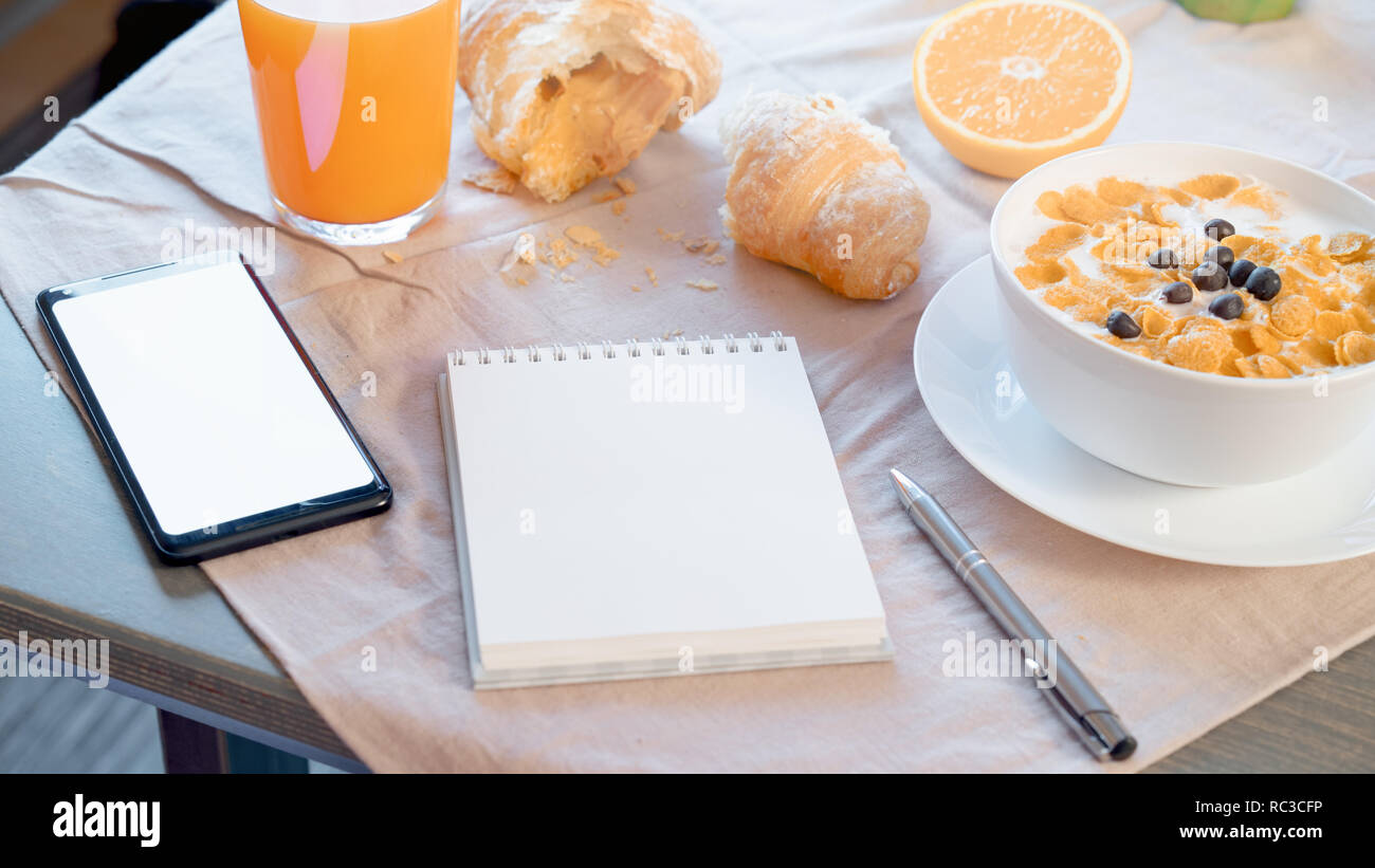 Corn Notepad Close up of Notepad and mobile phone with Blank screen. Bowl with corn ...