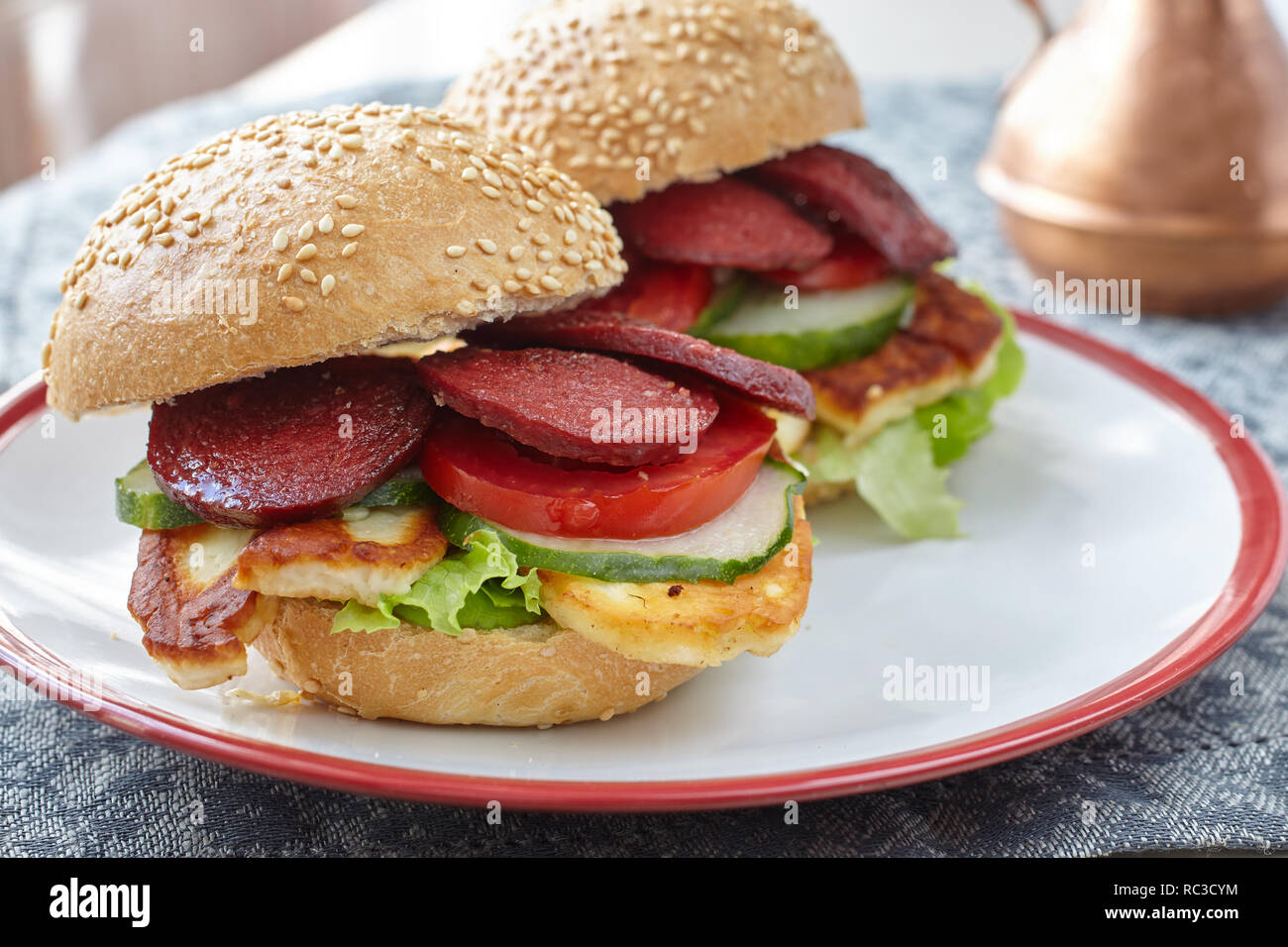 Turkish burgers with sucuk, halloumi cheese, and vegetables Stock Photo