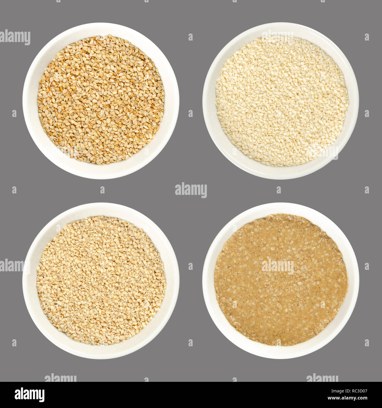 Sesame in bowls, over gray. Fruits of Sesamum, also benne. Raw, peeled and unpeeled, natural and white sesame seeds. Gomashio and Tahini. Stock Photo
