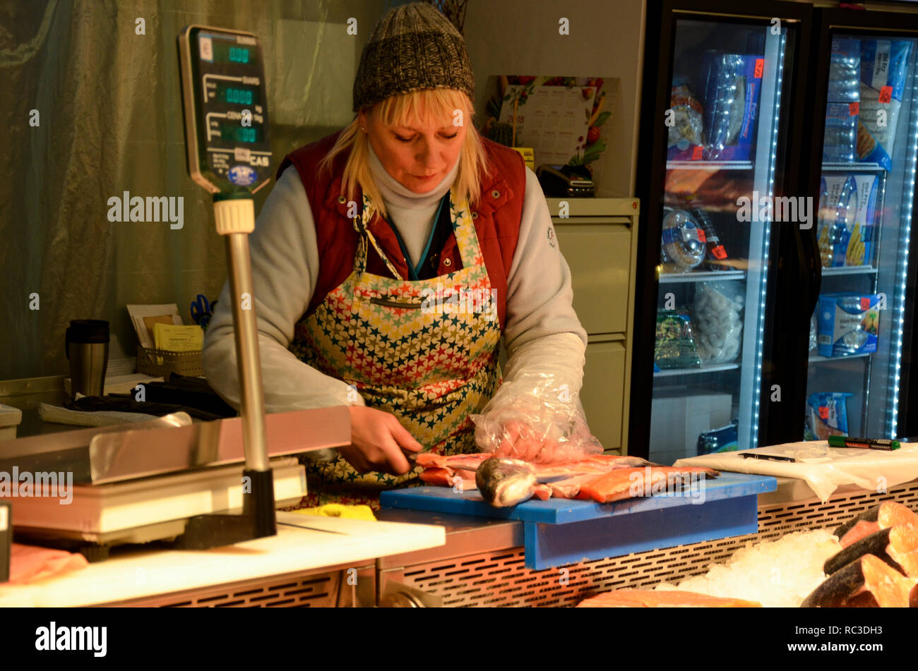 A fishmonger serves a customer, Riga Central Market, Europe's largest market and bazaar, Riga, Republic of Latvia, Baltics, December 2018 Stock Photo