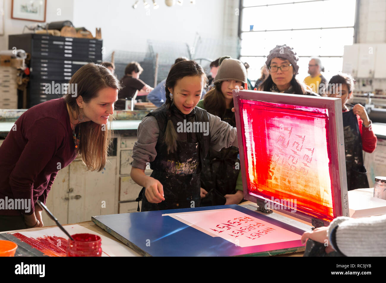 Seattle, Washington, USA. 12th Janaury 2019.  A group of young women screen printing at the Pratt Fine Arts Center print studio. Supporters were invited to create positive resistance poster prints at a work party for the upcoming Womxn’s March on Seattle 2019. The rally and march, organized by Seattle Womxn Marching Forward, will be held on January 19, 2019 kicking off a weekend of building power through community, protest, and activism. Credit: Paul Christian Gordon/Alamy Live News Stock Photo