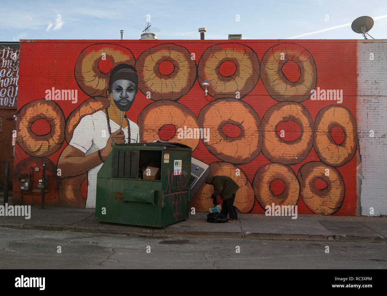 Detroit, USA. 13th Jan, 2019. A homeless man is looking for something useful in a dumpster. Although the population of the former automobile metropolis is rising again, the city still has to struggle with social problems. Credit: Boris Roessler/dpa/Alamy Live News Stock Photo