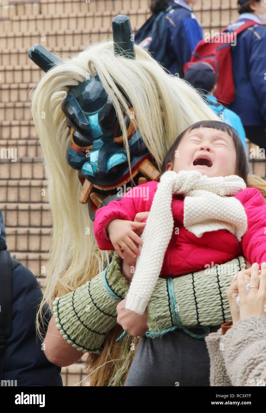 Yokohama, Japan. 12th Jan, 2019. A demon masked man called Namahage from Akita prefecture, northern Japan holds a crying baby during a promotional event for Akita at the Hakkeijima Sea Paradise aquarium in Yokohama, suburban Tokyo on Saturday, January 12, 2019. Japanese folk rituals including Namahage were approved for addition to UNESCOs Intangible Cultural Heritage list last year. Credit: Yoshio Tsunoda/AFLO/Alamy Live News Stock Photo
