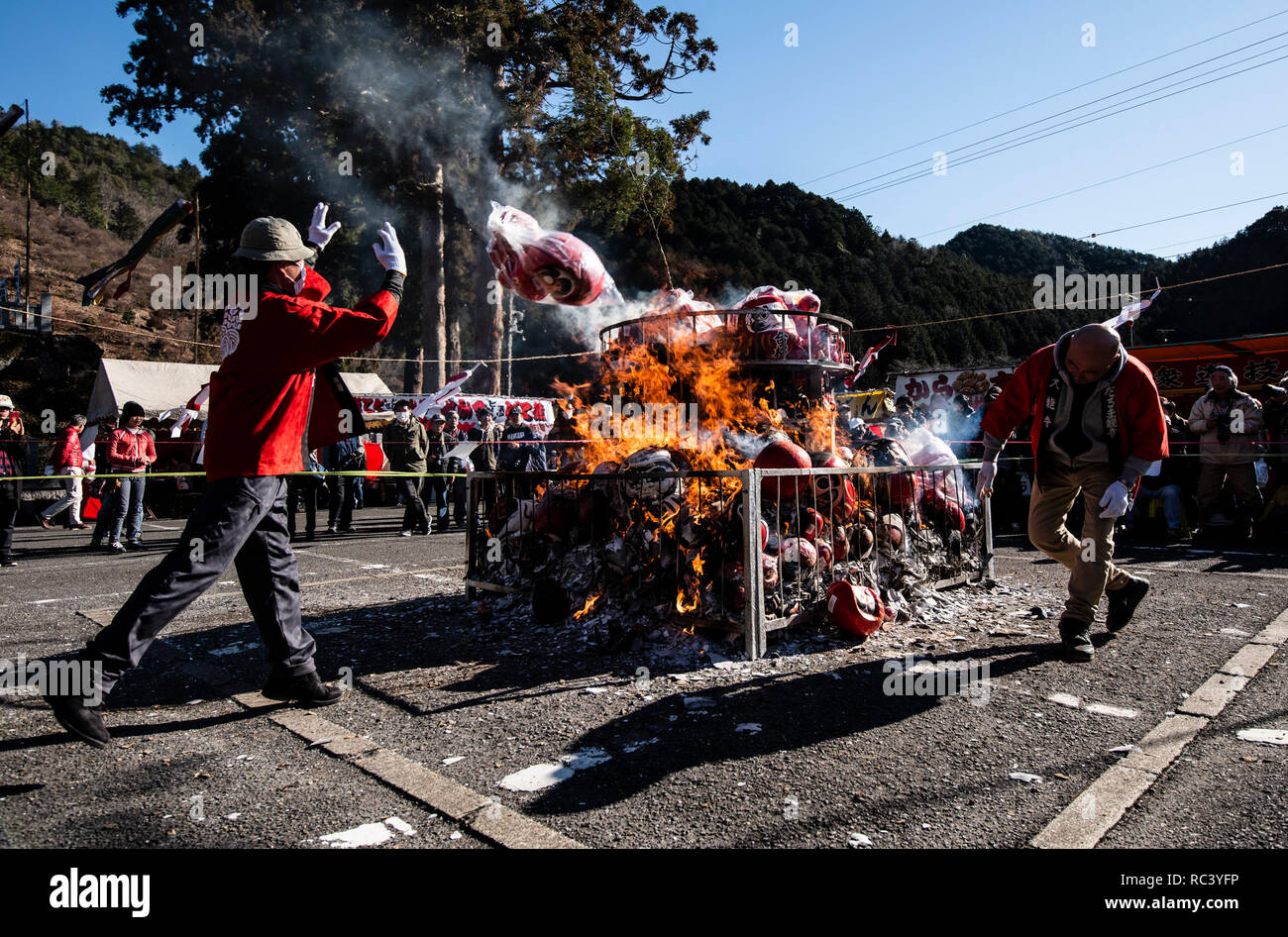 JANUARY 13, 2019 Men throw Daruma dolls on to a stack of burning