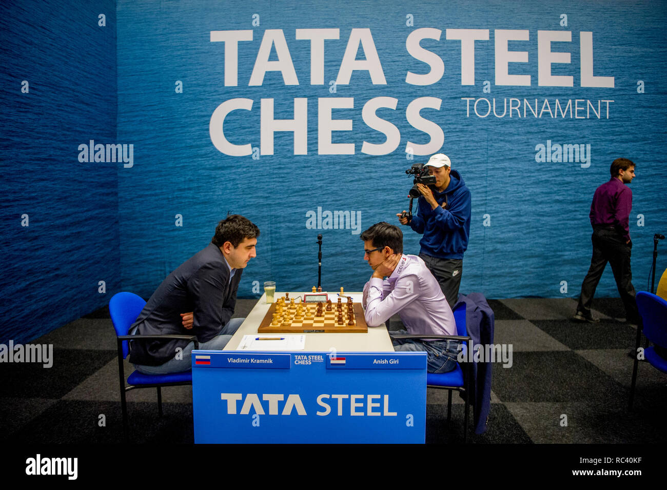 Magnus Carlsen at Tata Steel Chess 2019, Anish Giri walking…