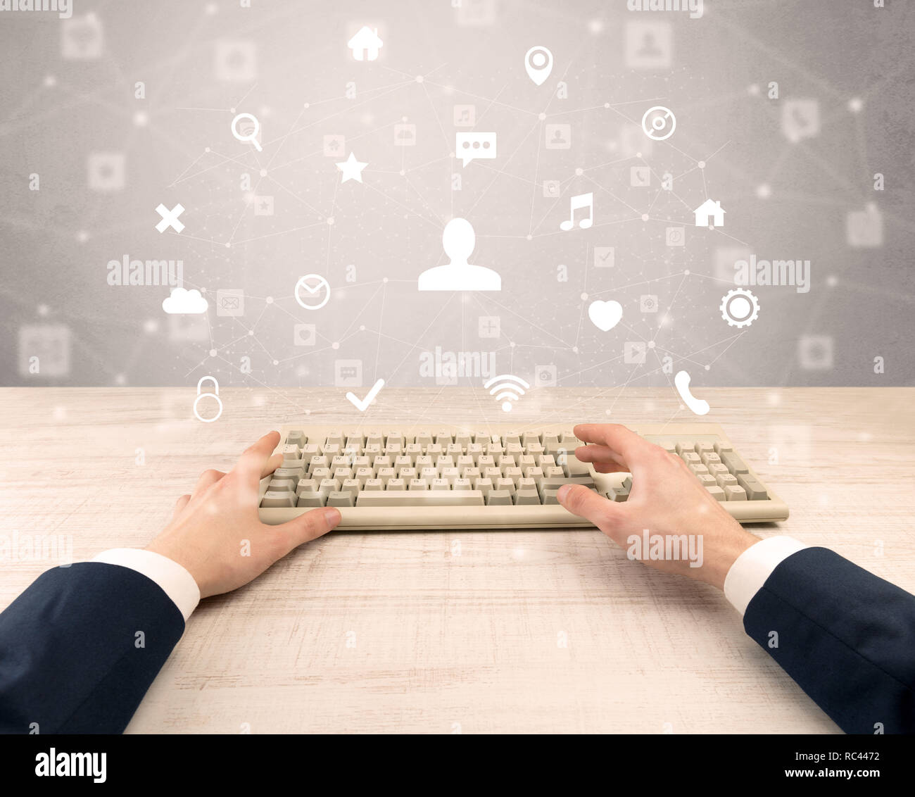 First person view of hand typing with social media concept icons around ...