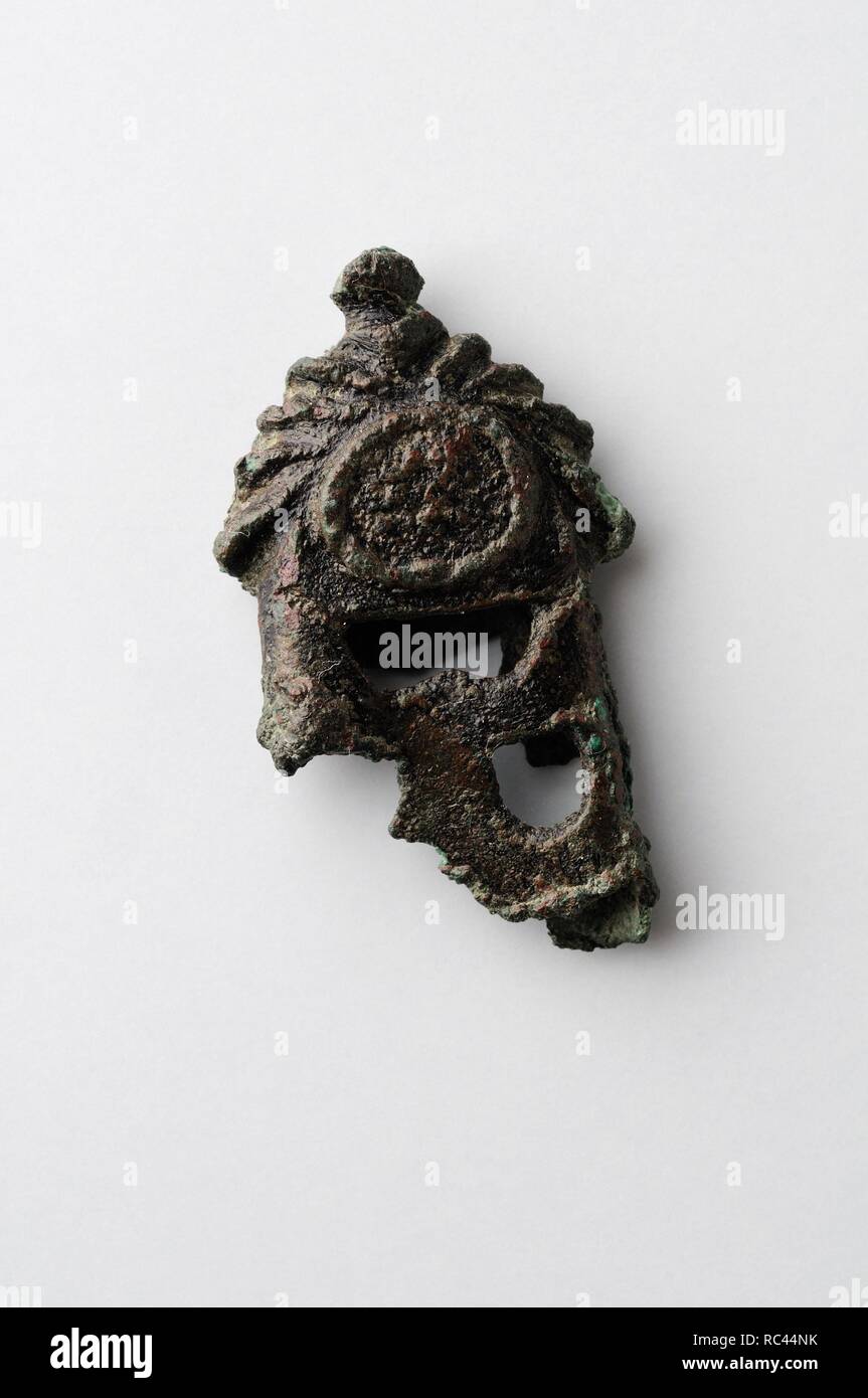 Small bronze finish decorated with side stripes. 3.9 cms x 2.3 cms - Medieval period from the archaeological site of ' La Magistral ' in Alcala de Henares - ' Burgo de Santiuste Museum ' (Madrid). SPAIN. Stock Photo