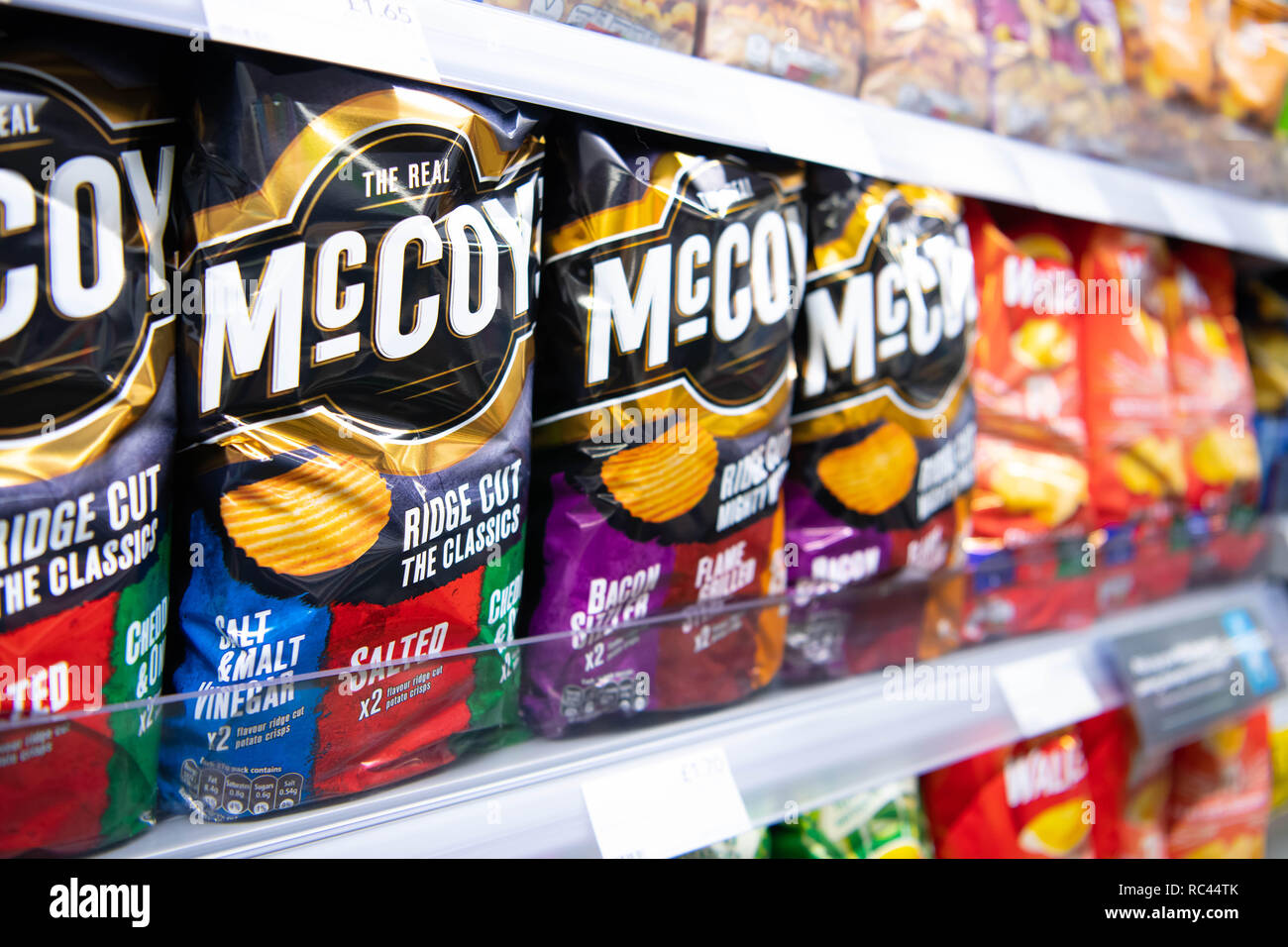 Multipack packets of McCoy crisps on sale on a shelf in a supermarket