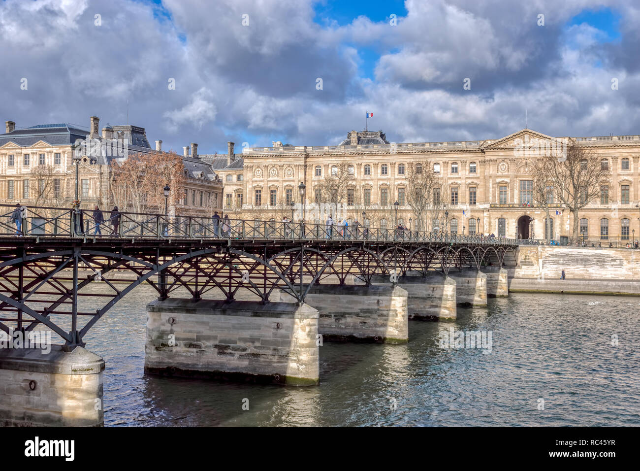 People walking on Pont des Arts - Paris, France Stock Photo