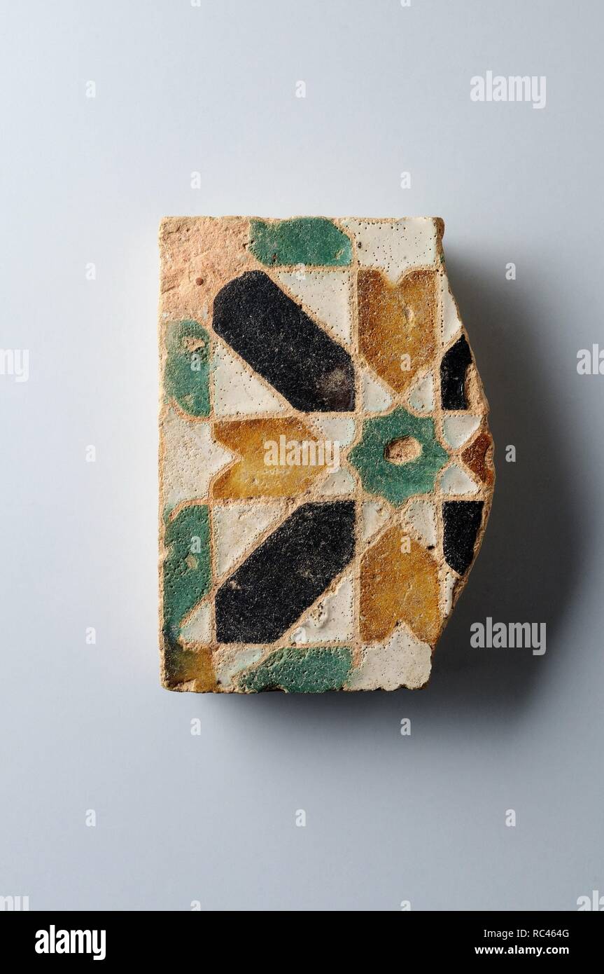 Glazed ceramic tile with geometric decoration 10 x 9, 5 cm. (15 th CE ) - Modern era belonging of the ' Burgo de Santiuste Museum' in Alcalá de Henares. (Madrid). SPAIN. Stock Photo