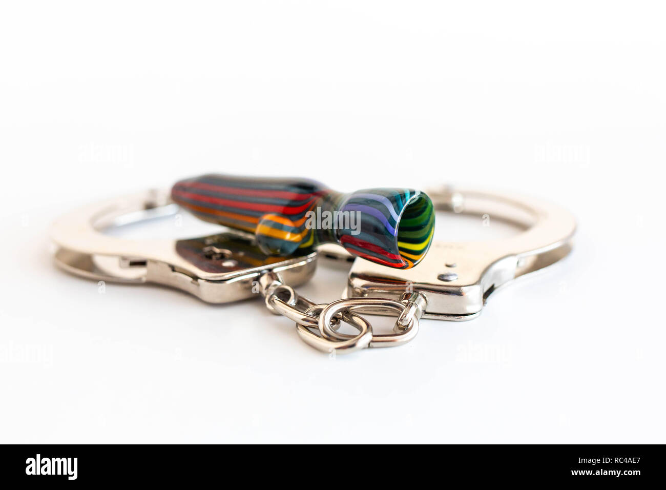 Concept of illegal pot smoking with handcuffs isolated Stock Photo