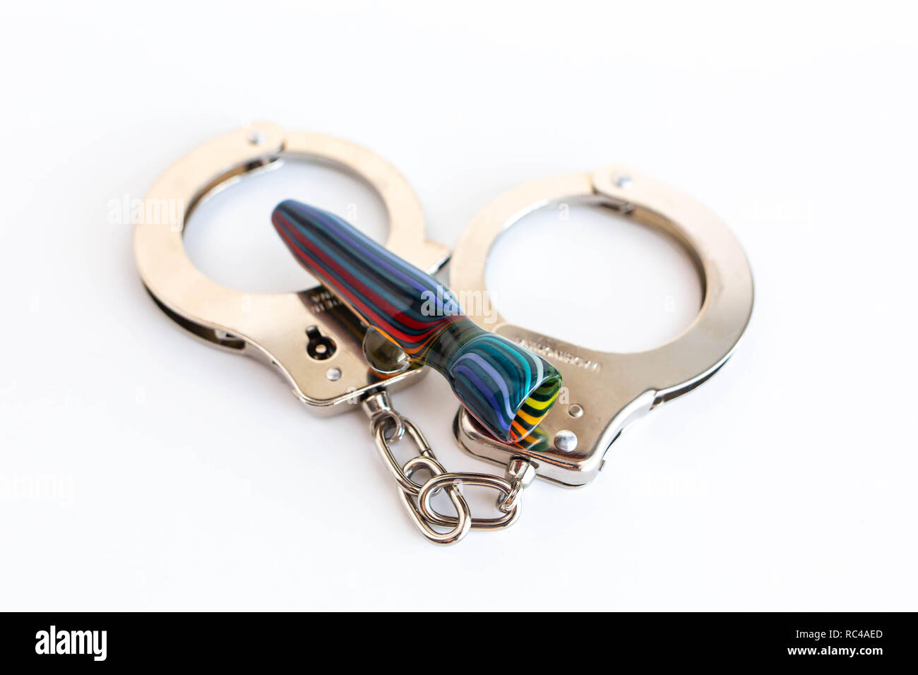 Concept of illegal pot smoking with handcuffs isolated Stock Photo