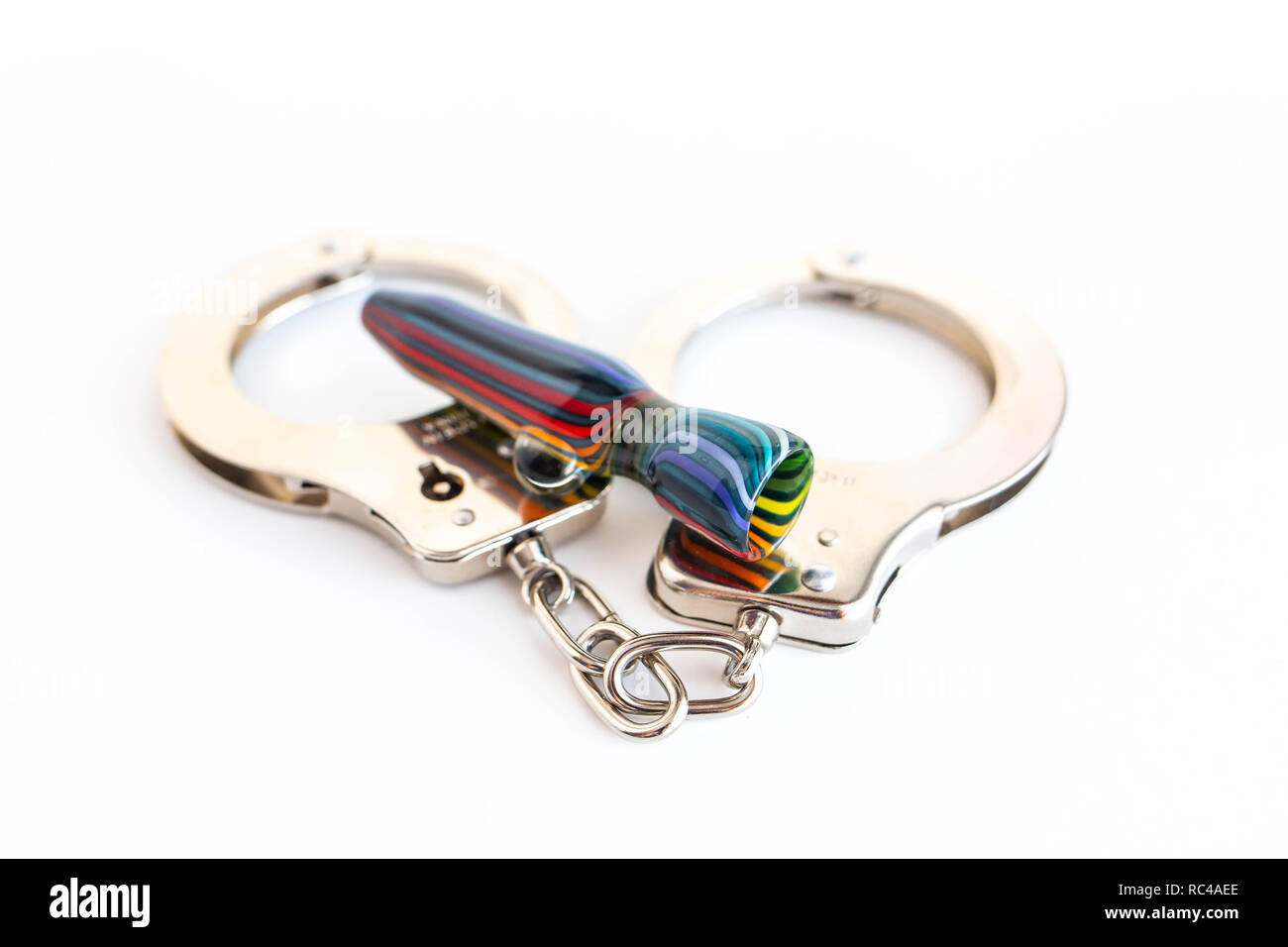 Concept of illegal pot smoking with handcuffs isolated Stock Photo