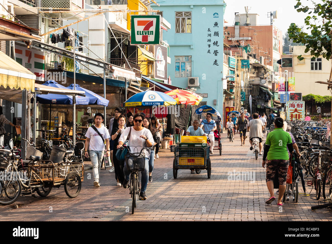 Hong Kong, China - October 8 2018: People walking along the main street of the town on Cheung Chau island, an outlying island in Hong Kong, China Stock Photo