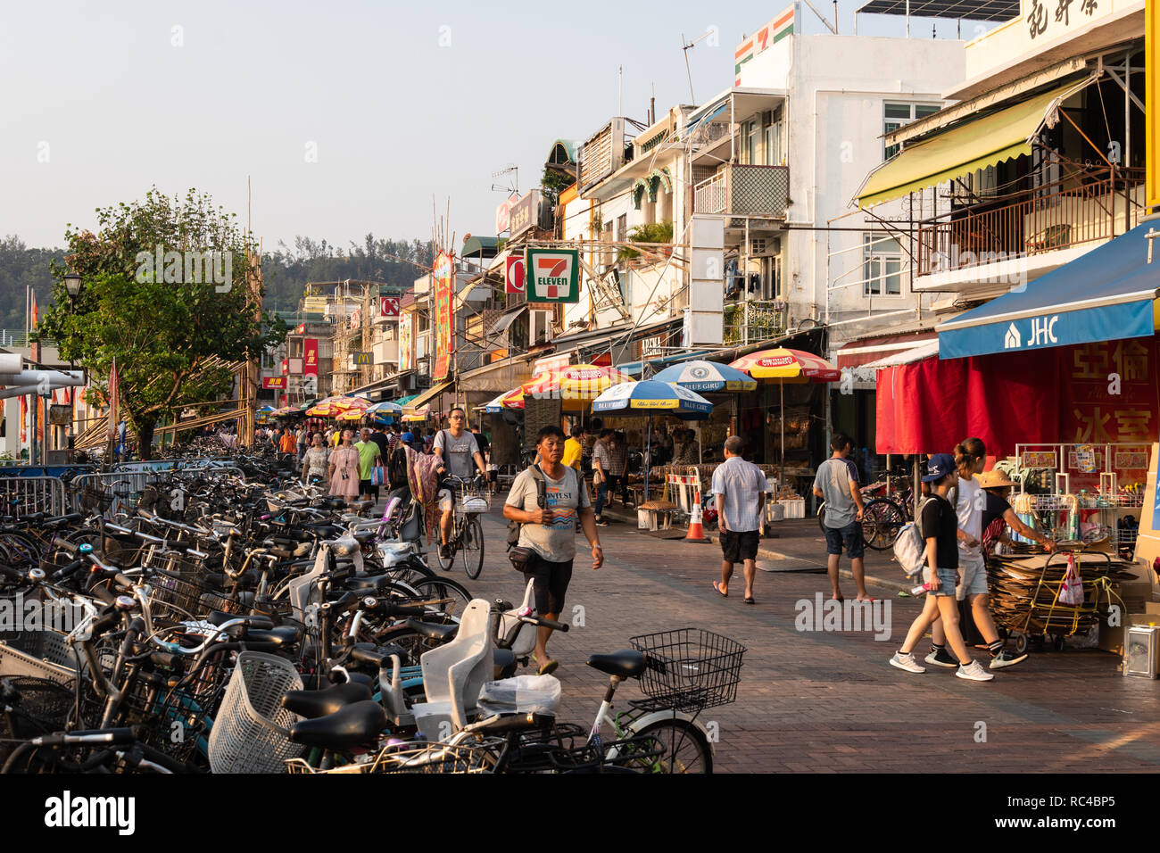 Hong Kong, China - October 8 2018: People walking along the main street of the town on Cheung Chau island, an outlying island in Hong Kong, China Stock Photo