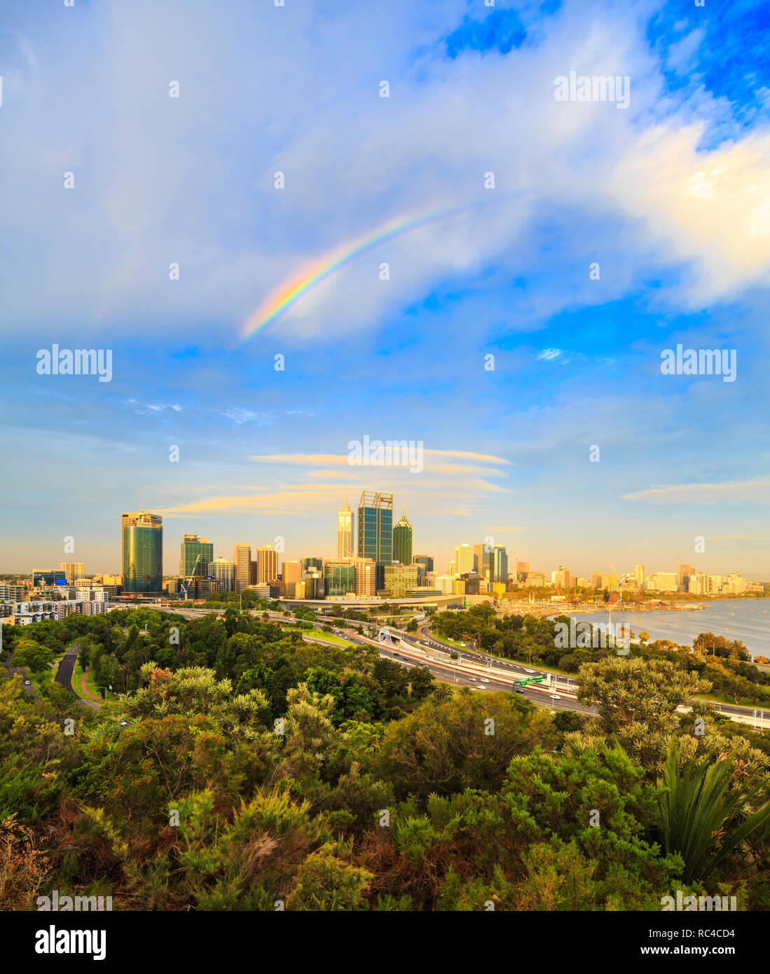 Perth Australia. The city glowing in the late afternoon sun with a rainbow overhead as viewed from the lookout in  Kings Park, Perth,Western Australia Stock Photo