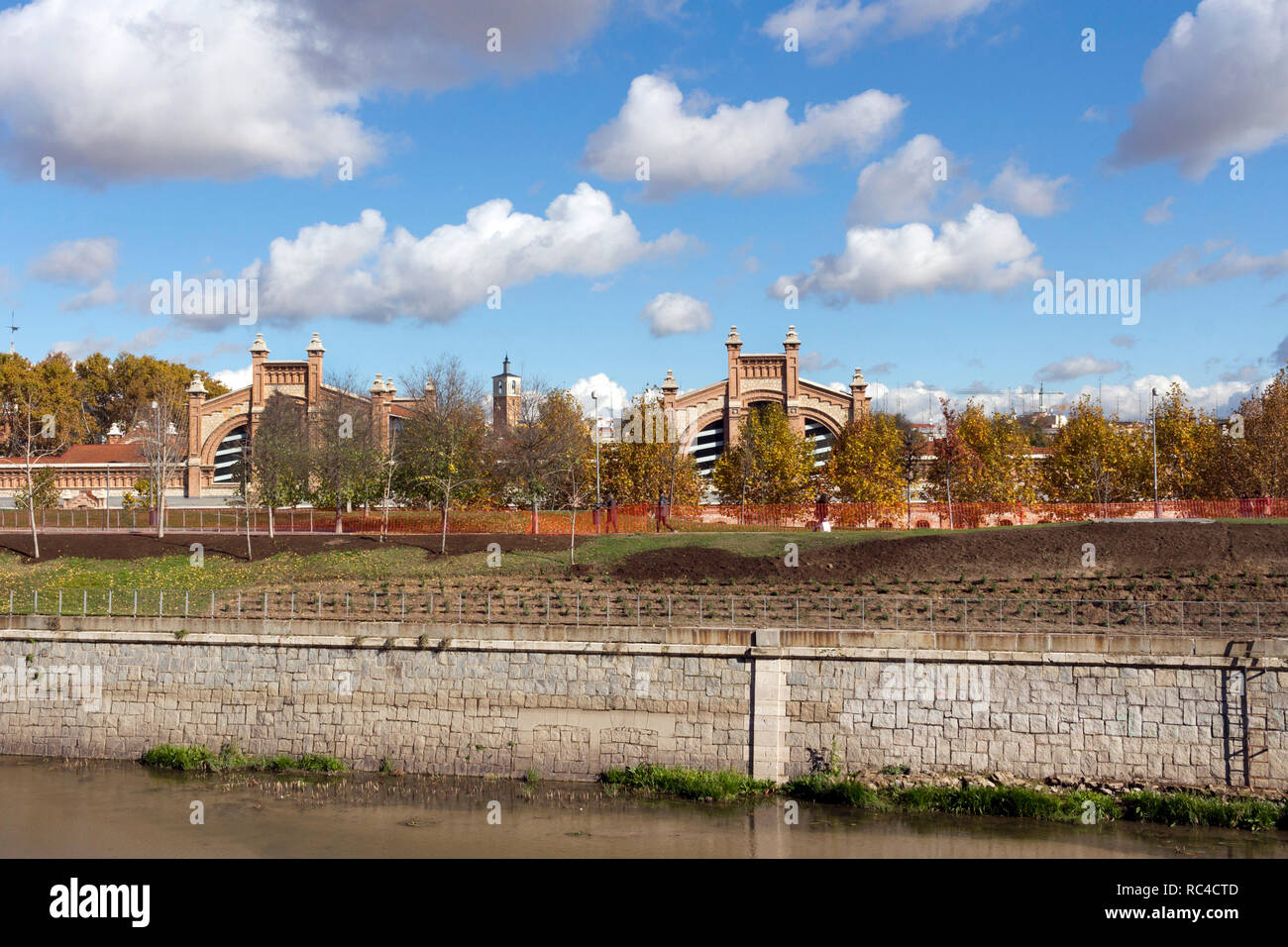 Madrid - Madrid Rio a green area for sports and leisure on Manzanares River. In the background Matadero Madrid cultural center Stock Photo