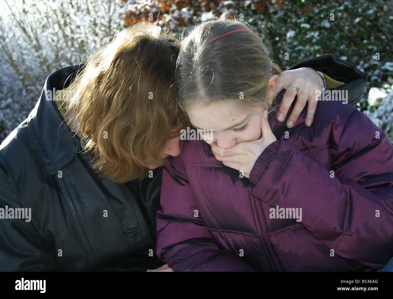 Sad mother and teenage daughter,outside Stock Photo