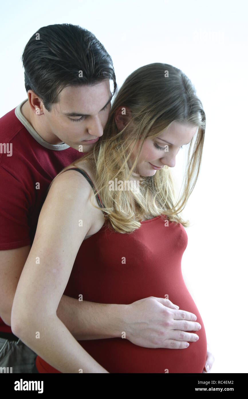 A Beautiful Pregnant Woman And Her Handsome Husband Are Hugging And Touching Her Pregnant Belly Stock Photo Alamy
