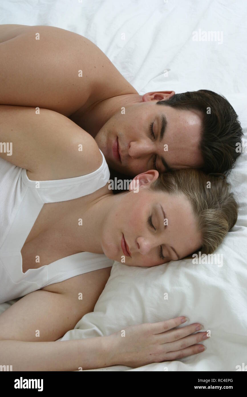 Pregnant wife and husband sleeping together Stock Photo