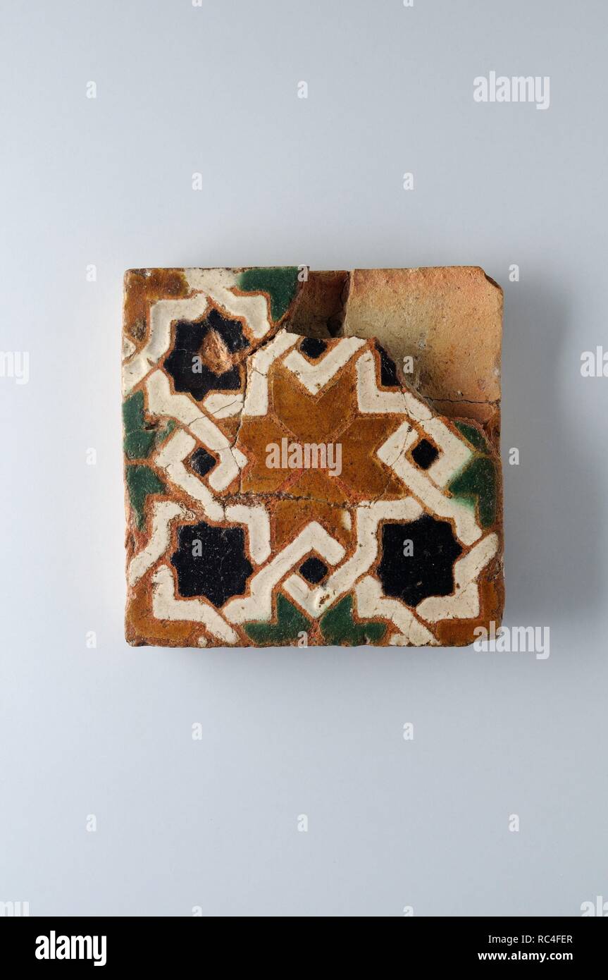 Glazed ceramic tile with geometric decoration 10 x 9, 5 cm. (15 th CE ) - Modern era belonging of the ' Burgo de Santiuste Museum' in Alcalá de Henares. (Madrid). SPAIN. Stock Photo