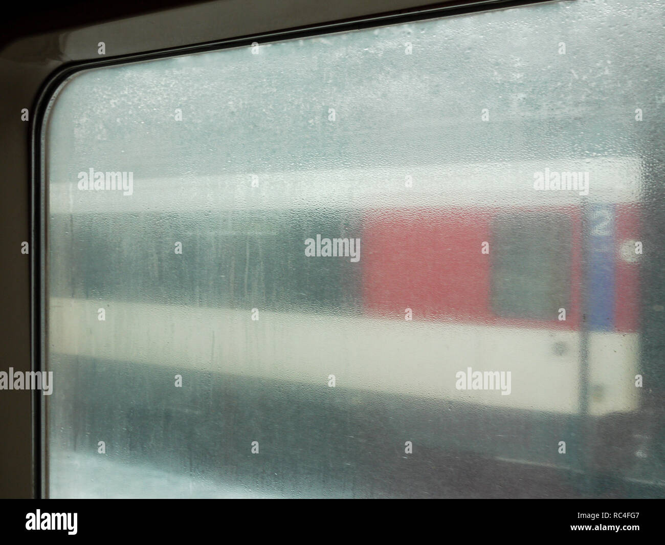 Railway station quay, seen through a fogged train window, Domodossola ...