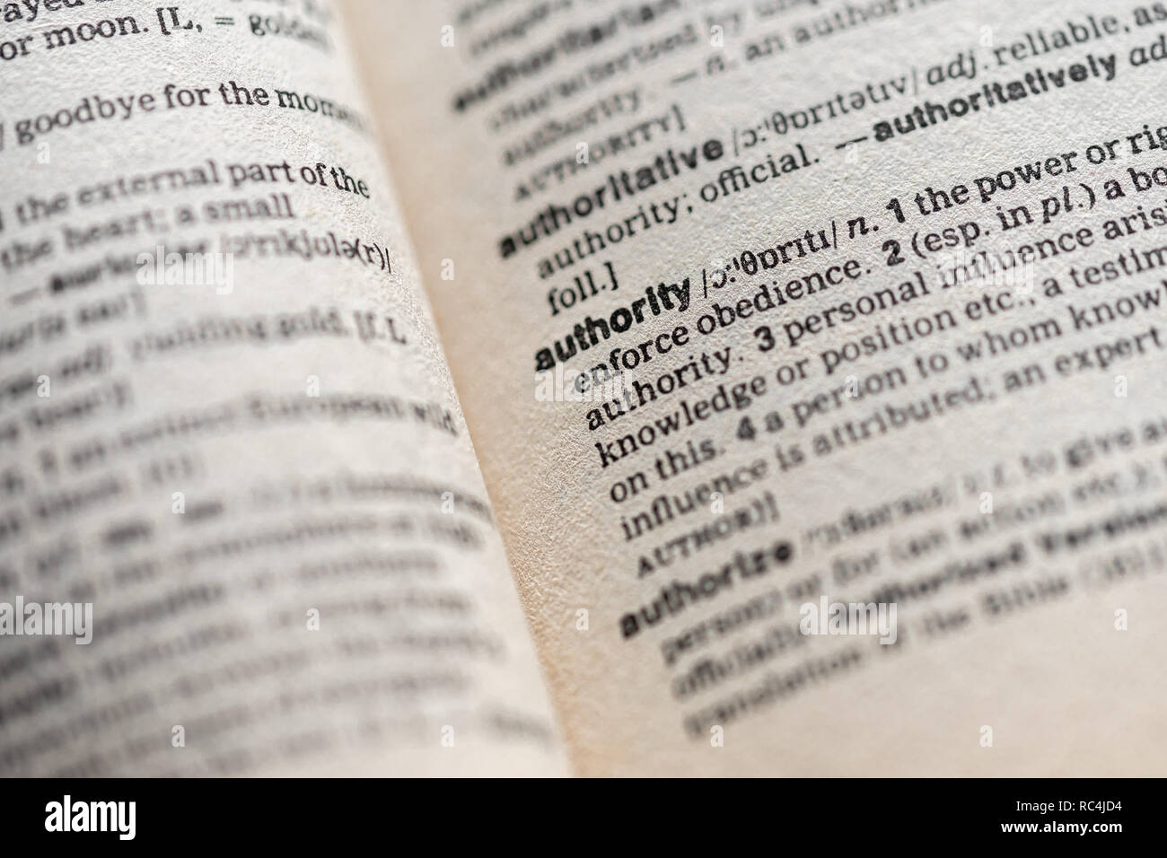Close up of the word authority on a page inside an English dictionary -  authority concept Stock Photo
