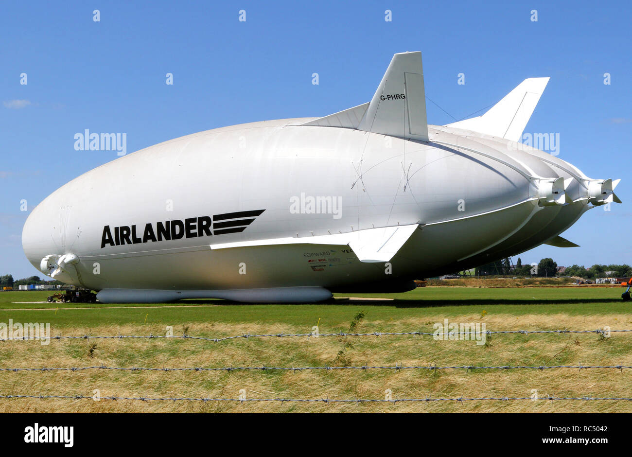 View of the Airlander, the longest aircraft in the world. The £32m aircraft - nicknamed 'The Flying Bum' was originally unveiled to the public at a naming ceremony by HRH The Duke of Kent in April 2016, but a few weeks later it crashed at the end of a test flight. At 92-metre long, the Airlander 10 is the longest aircraft in the world.  The world's longest aircraft has been retired from service as developers prepare to start work on a new model. Stock Photo