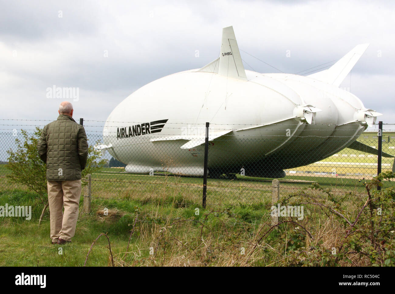 View of the Airlander, the longest aircraft in the world. The £32m aircraft - nicknamed 'The Flying Bum' was originally unveiled to the public at a naming ceremony by HRH The Duke of Kent in April 2016, but a few weeks later it crashed at the end of a test flight. At 92-metre long, the Airlander 10 is the longest aircraft in the world.  The world's longest aircraft has been retired from service as developers prepare to start work on a new model. Stock Photo
