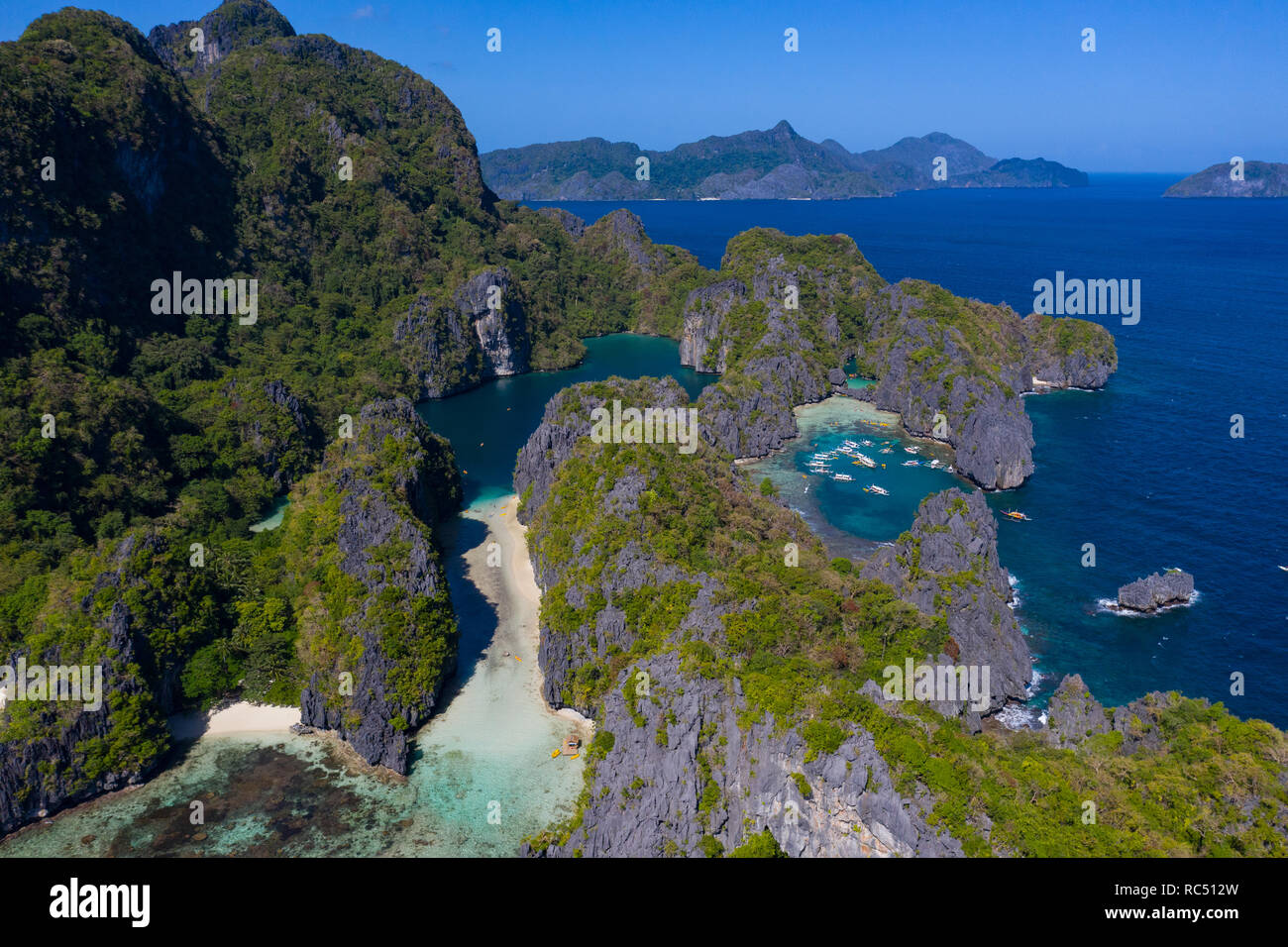Aerial view of small Lagoon to the right with boats and Big Lagoon on the left,Miniloc Island,El Nido,Palawan,Philippines Stock Photo