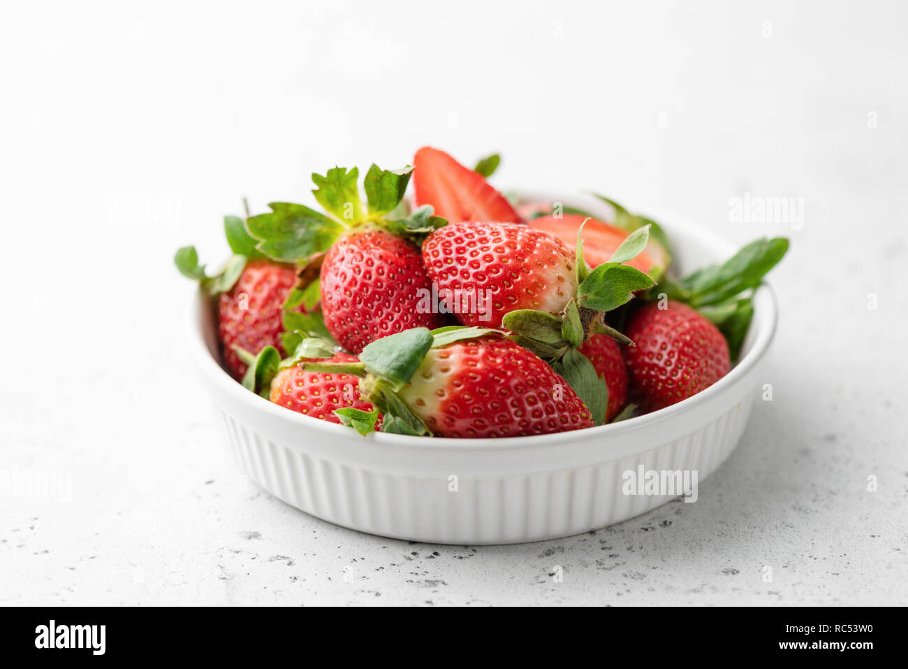 Fresh strawberries in bowl on white background, horizontal view, selective focus. Tasty strawberries. Healthy food Stock Photo