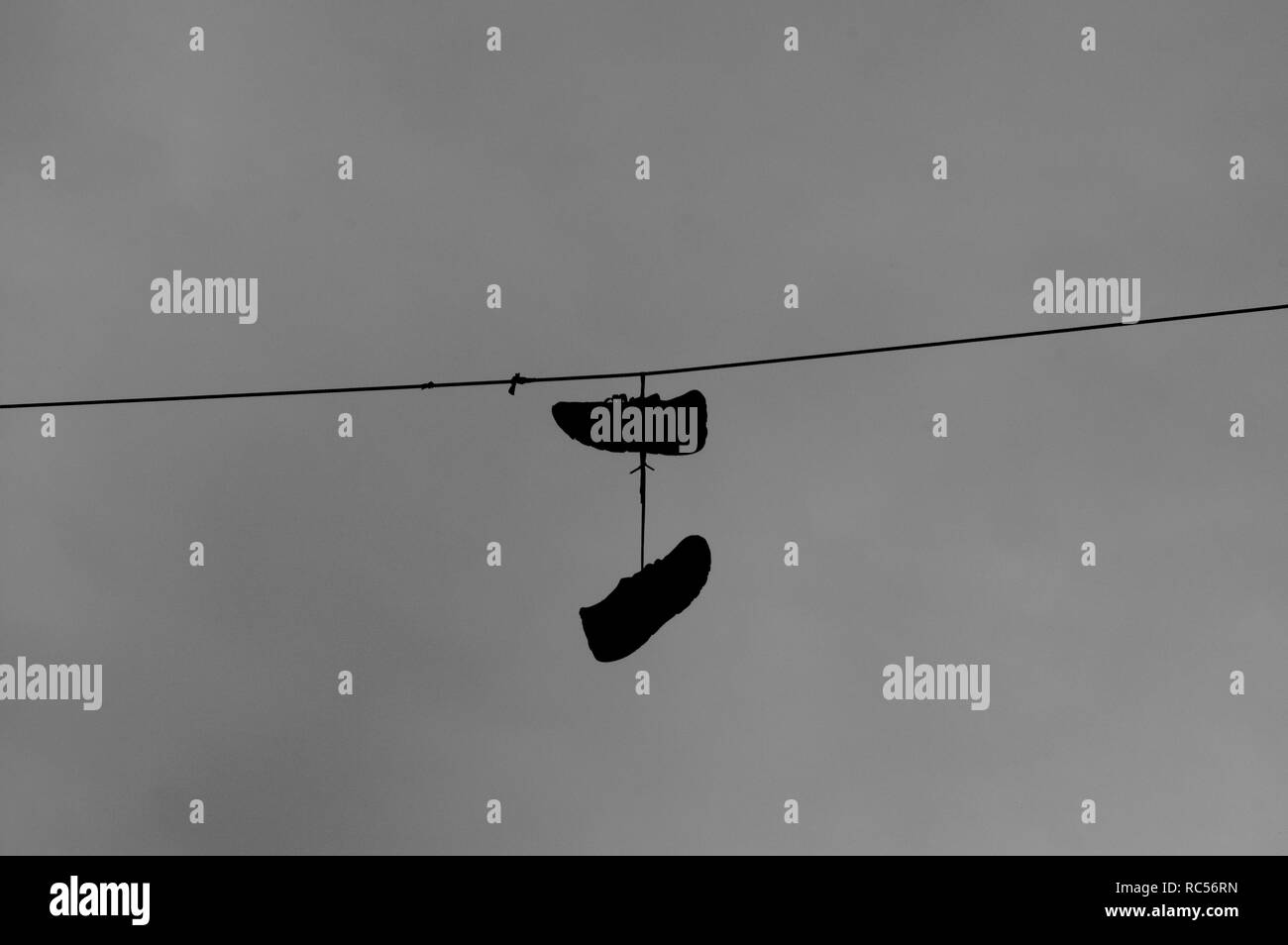 Sneakers hanging on wire Stock Photo Alamy
