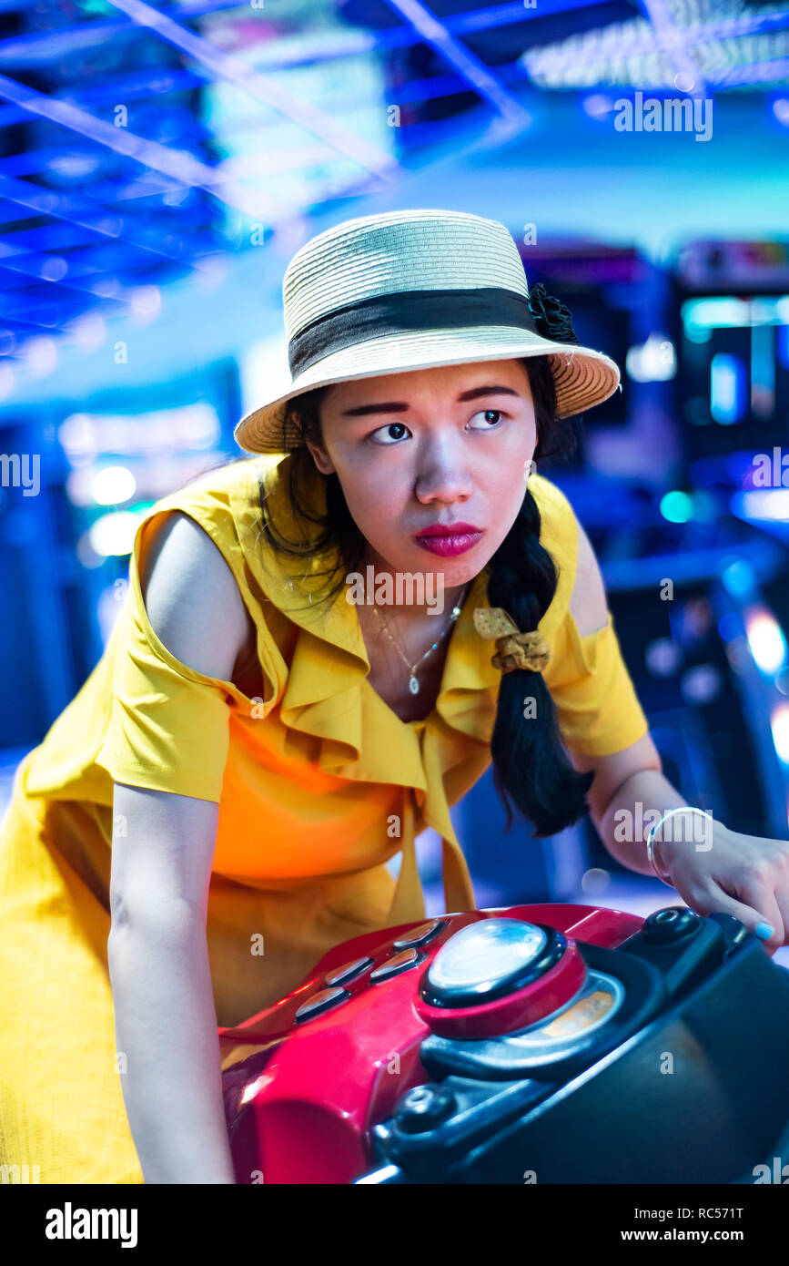 Girl playing games at arcade entertainment center Stock Photo