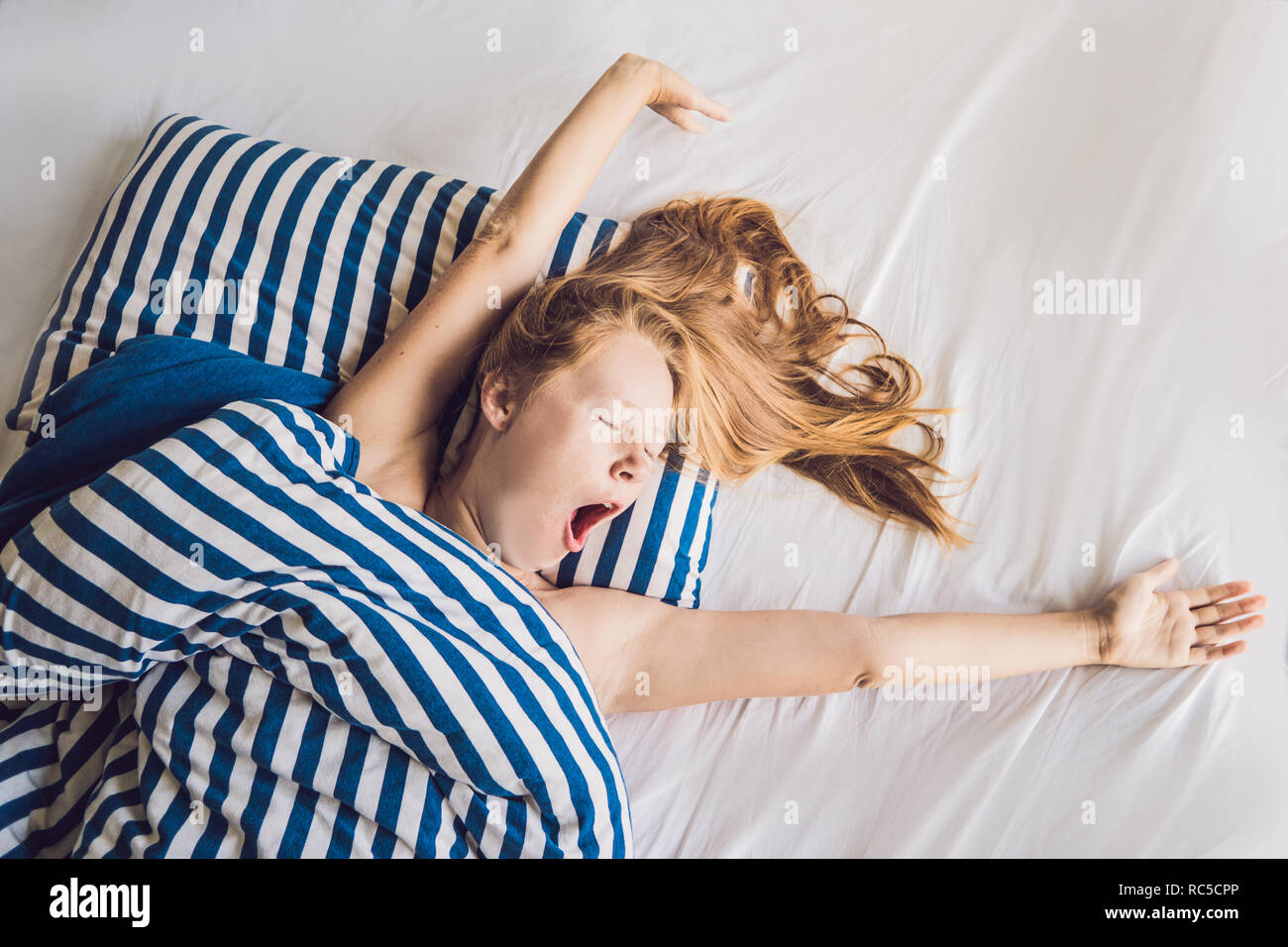 Beautiful young woman lying down in bed and sleeping. Do not get enough