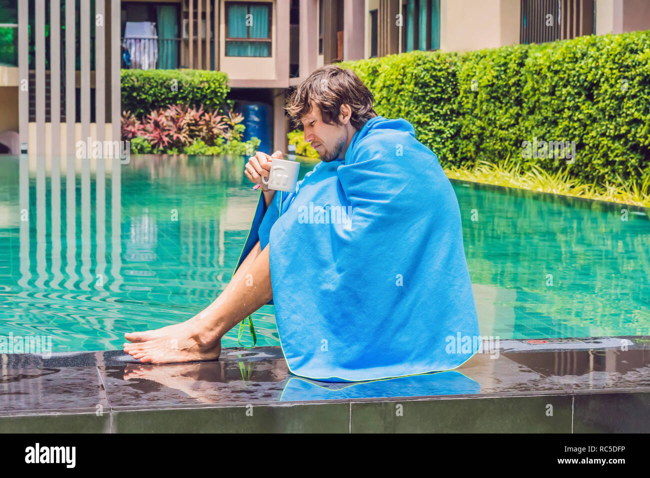 Sick man traveler. The man caught a cold on vacation, sits sad at the